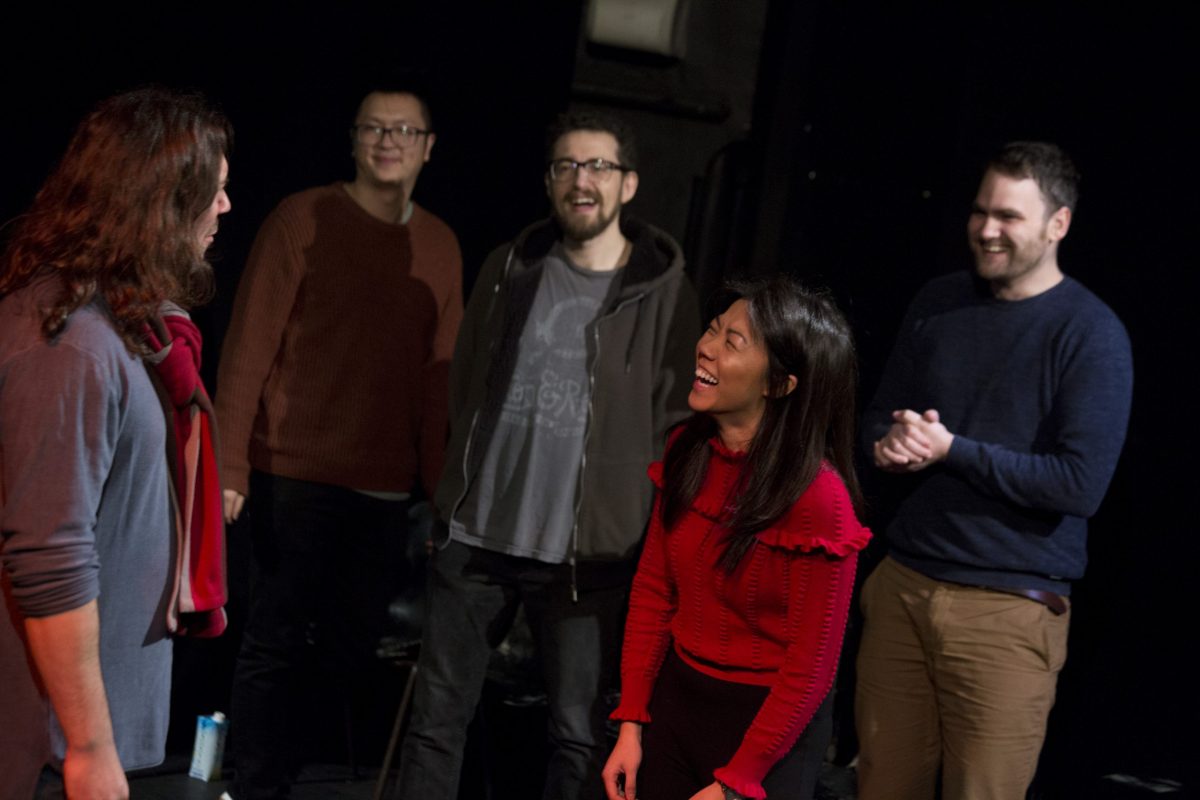 Improv comedy workshops in Manchester. People taking an improv comedy class laughing together